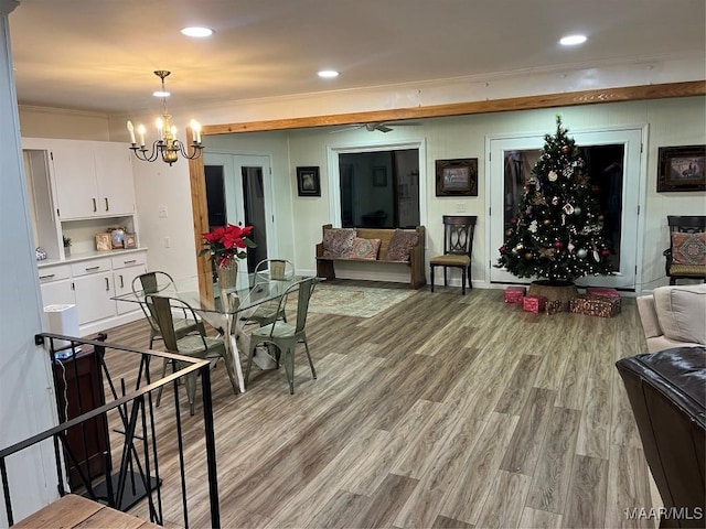 dining room featuring ornamental molding, light hardwood / wood-style floors, and a notable chandelier