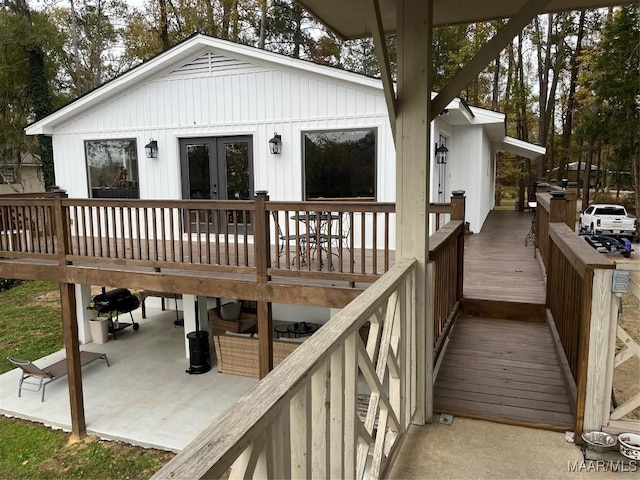 wooden terrace with grilling area and french doors