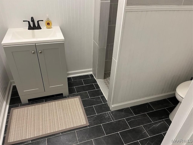 bathroom featuring tile patterned flooring, a shower, vanity, and wood walls