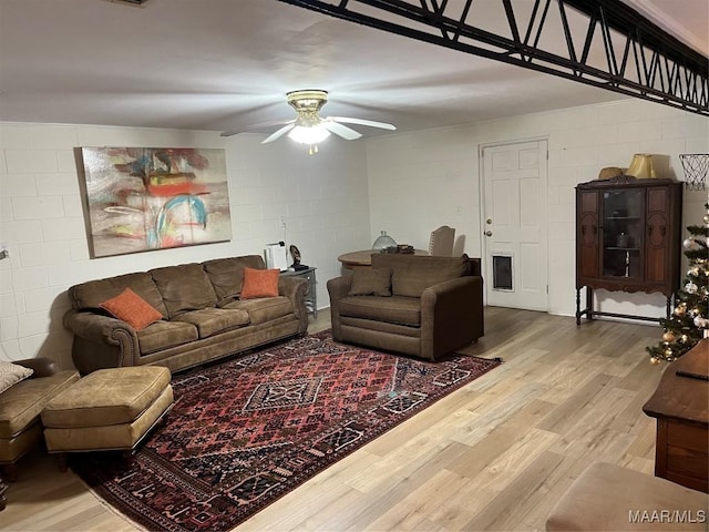 living room featuring light wood-type flooring and ceiling fan