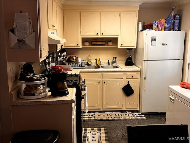 kitchen featuring white refrigerator, crown molding, sink, and gas range