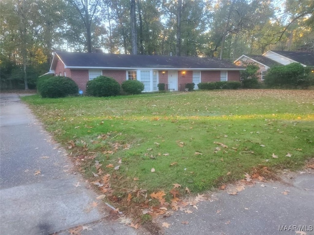 ranch-style house with a front lawn