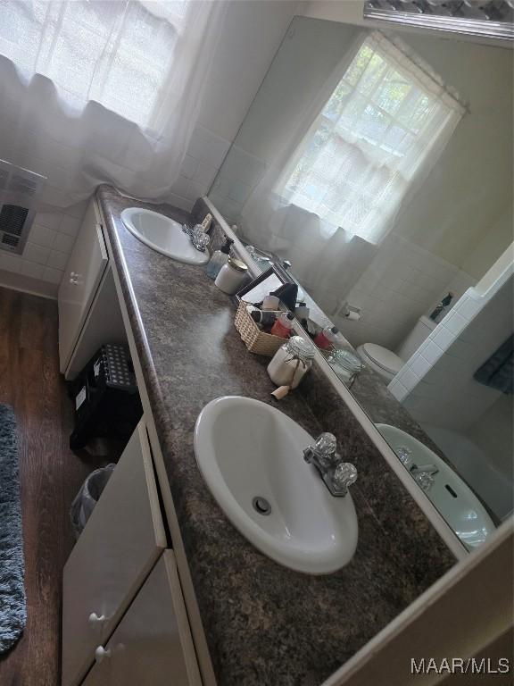 bathroom featuring hardwood / wood-style floors, vanity, and toilet