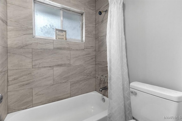 bathroom featuring shower / tub combo and toilet