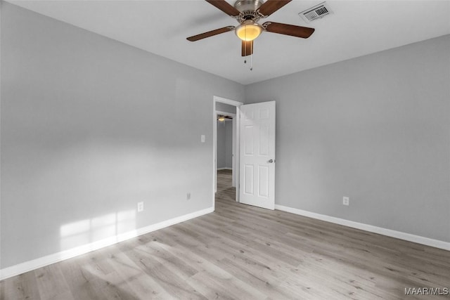 empty room featuring ceiling fan and light wood-type flooring