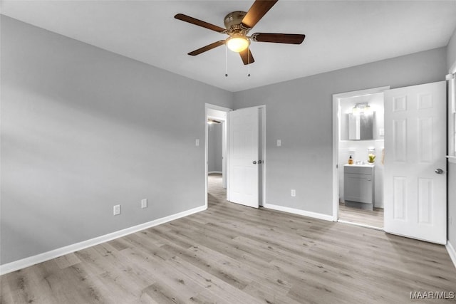 unfurnished bedroom featuring ensuite bath, ceiling fan, and light wood-type flooring