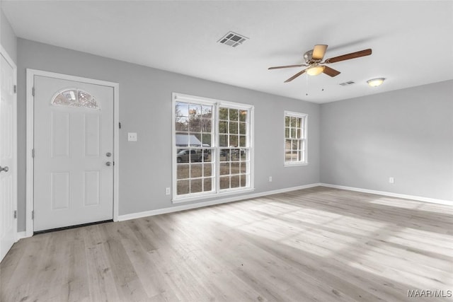 foyer with ceiling fan and light hardwood / wood-style floors