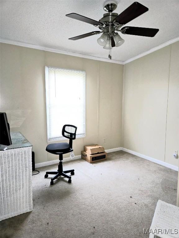 home office featuring carpet flooring, a textured ceiling, ceiling fan, and crown molding