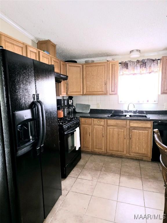 kitchen featuring tasteful backsplash, ornamental molding, sink, black appliances, and light tile patterned flooring