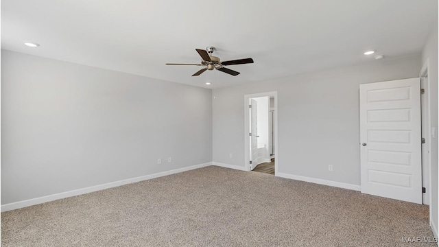 carpeted spare room with ceiling fan