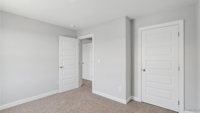 unfurnished bedroom featuring carpet floors and a closet