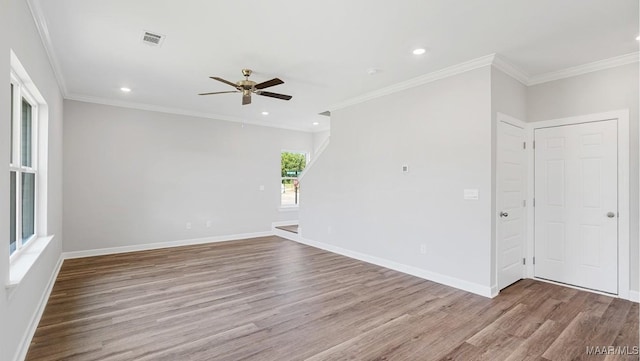 empty room with crown molding, ceiling fan, and light wood-type flooring