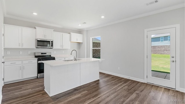 kitchen featuring dark hardwood / wood-style flooring, stainless steel appliances, sink, white cabinetry, and an island with sink