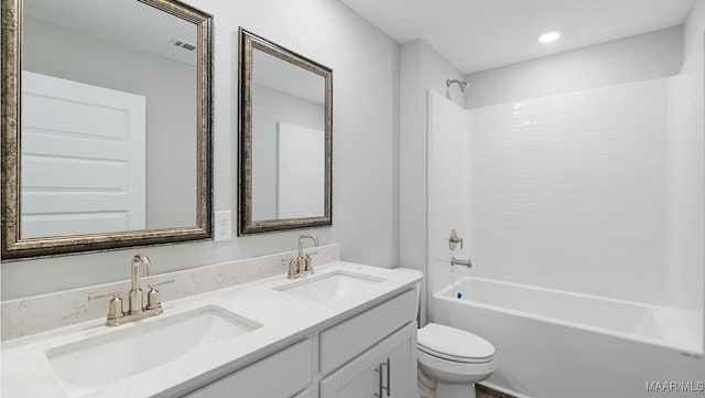 full bathroom with vanity, shower / bath combination, and toilet