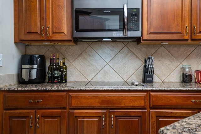 kitchen featuring tasteful backsplash and black electric stovetop