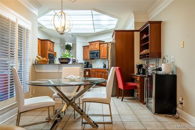 dining area with ornamental molding, a notable chandelier, and light tile patterned flooring