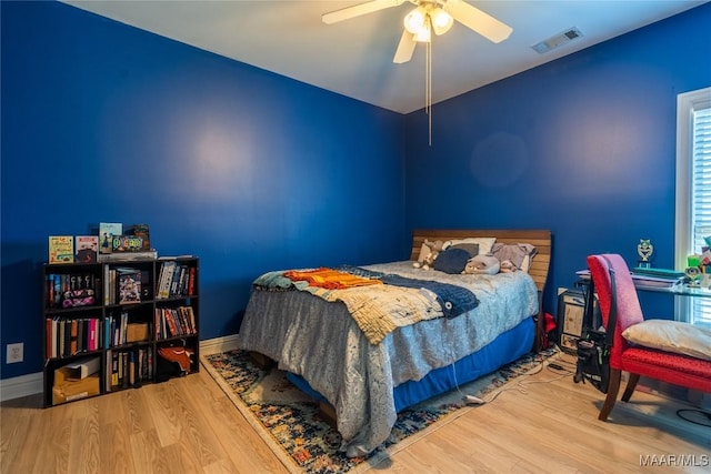 bedroom featuring hardwood / wood-style flooring and ceiling fan