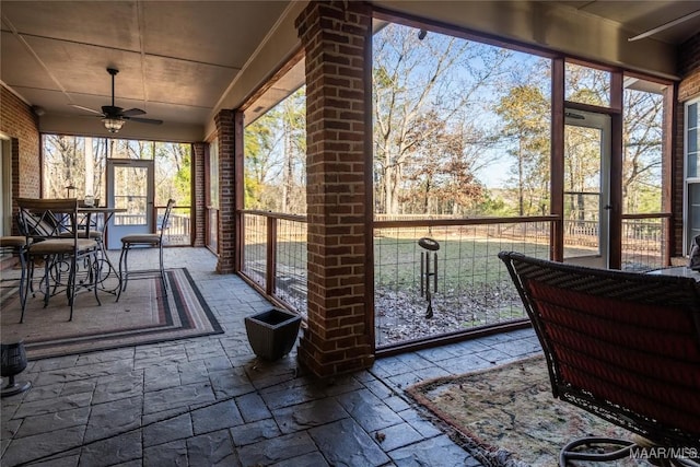 sunroom featuring ceiling fan