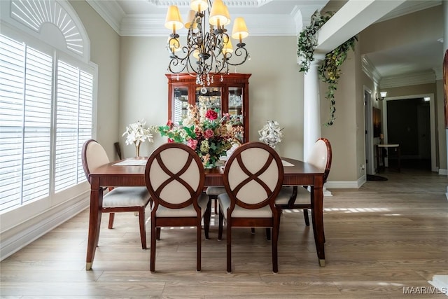 dining room with crown molding, hardwood / wood-style flooring, and a notable chandelier