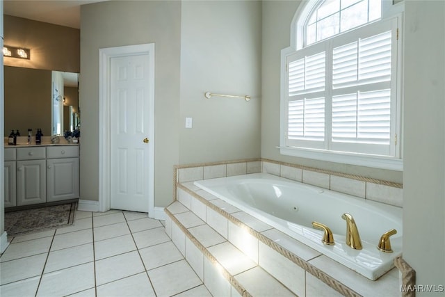 bathroom with tile patterned floors, vanity, and tiled tub