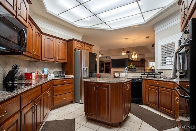 kitchen featuring black appliances, light tile patterned floors, decorative light fixtures, stone countertops, and a center island