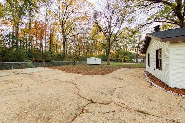 view of patio featuring a storage unit