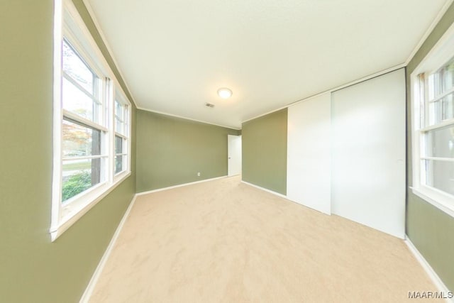 carpeted empty room featuring plenty of natural light