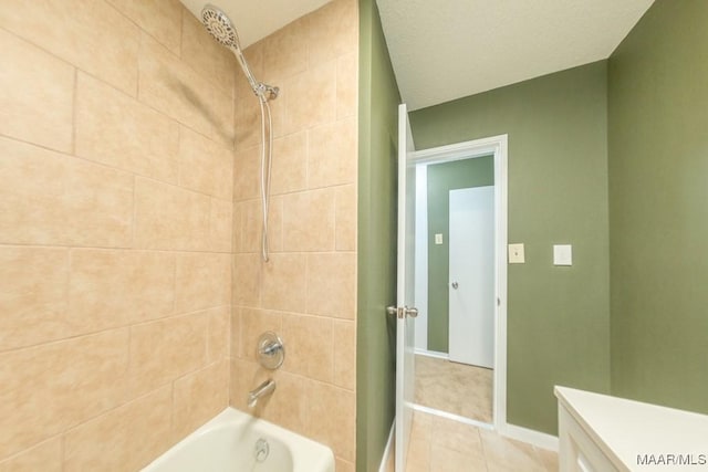 bathroom with vanity, tiled shower / bath combo, and tile patterned floors