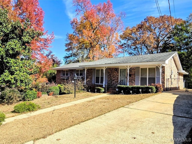 single story home featuring covered porch