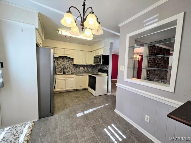 kitchen with backsplash, decorative light fixtures, dark tile patterned floors, a notable chandelier, and stainless steel appliances