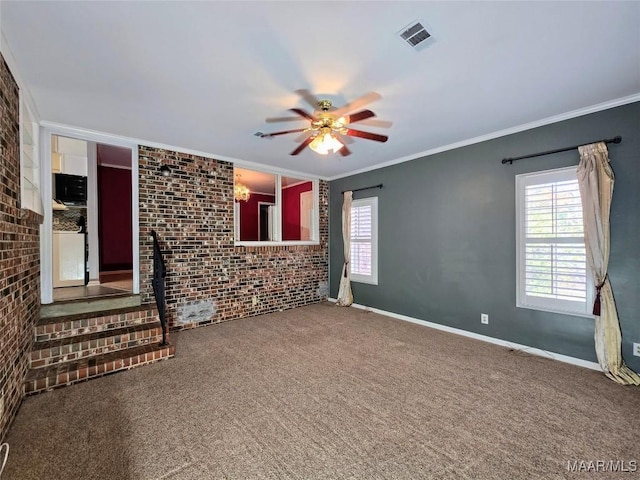 unfurnished living room with carpet floors, ceiling fan, crown molding, and brick wall