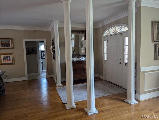 entryway featuring crown molding, plenty of natural light, and hardwood / wood-style flooring