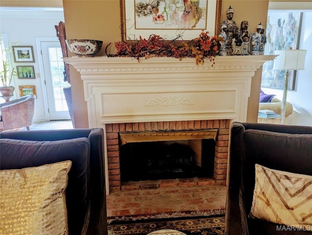 sitting room featuring a brick fireplace and ornamental molding