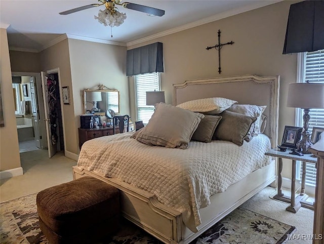 bedroom featuring connected bathroom, light colored carpet, ceiling fan, and crown molding