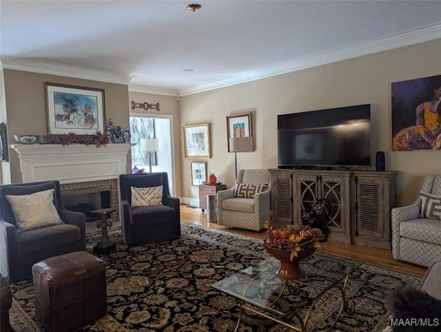 living room with hardwood / wood-style floors, a brick fireplace, and crown molding