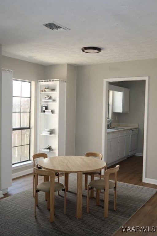 dining area with dark hardwood / wood-style floors