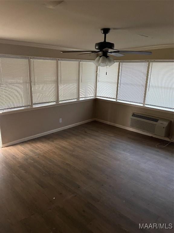 unfurnished sunroom featuring a wall mounted AC, ceiling fan, and plenty of natural light