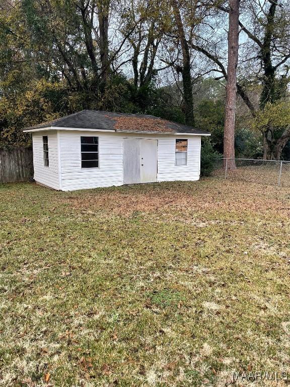 view of outbuilding with a yard