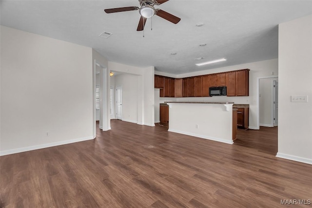 kitchen with ceiling fan, a center island, and dark hardwood / wood-style flooring