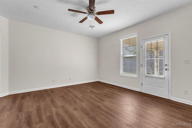 unfurnished room featuring ceiling fan and dark wood-type flooring