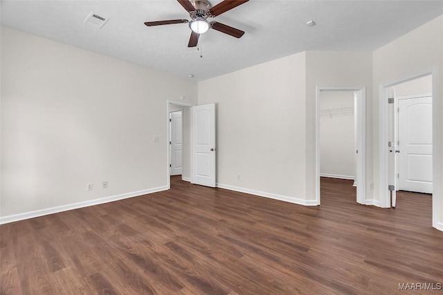 empty room with ceiling fan and dark wood-type flooring