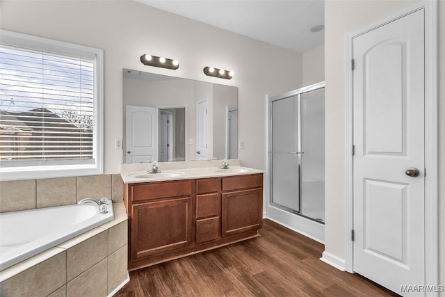 bathroom featuring hardwood / wood-style flooring, vanity, and independent shower and bath