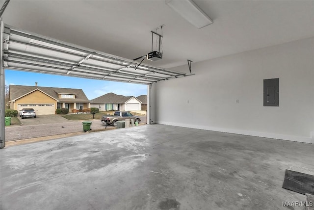 garage featuring electric panel and a garage door opener