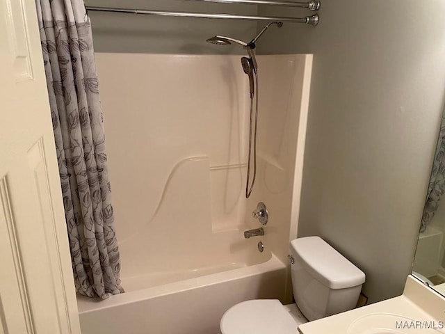 full bathroom featuring shower / bath combination with curtain, vanity, and toilet