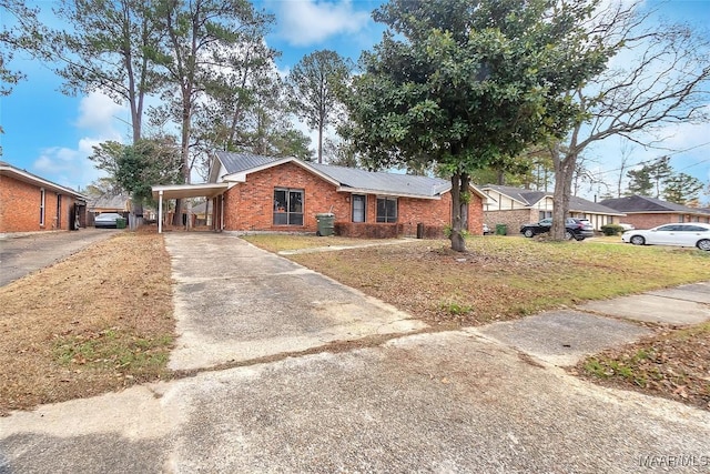 ranch-style home featuring a carport and a front yard