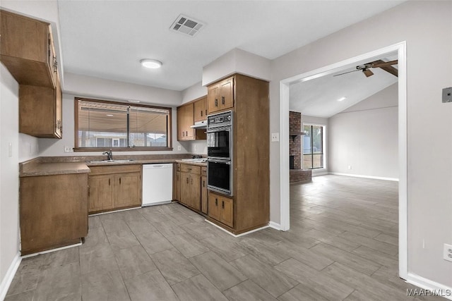 kitchen with sink, light hardwood / wood-style flooring, double oven, white dishwasher, and lofted ceiling