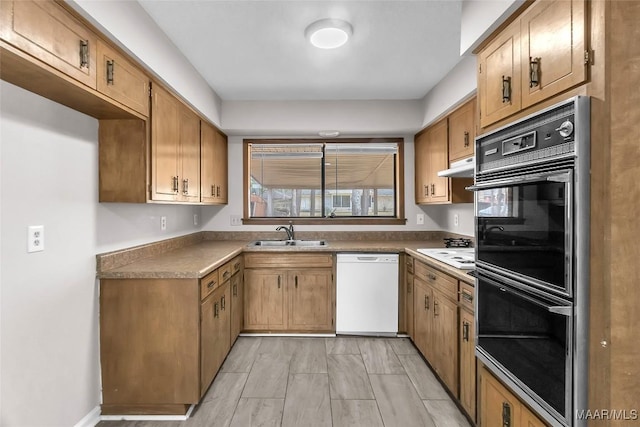 kitchen featuring white appliances and sink