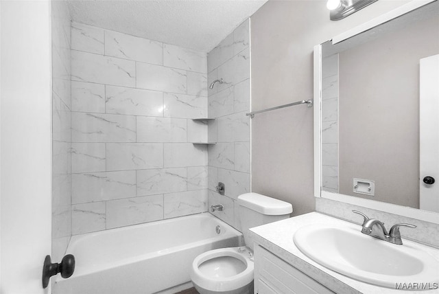 full bathroom with a textured ceiling, vanity, tiled shower / bath combo, and toilet