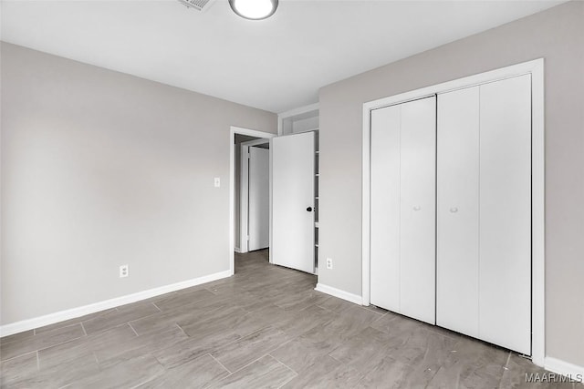 unfurnished bedroom featuring light hardwood / wood-style floors and a closet