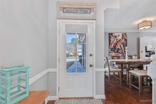 foyer entrance featuring wood-type flooring and a textured ceiling